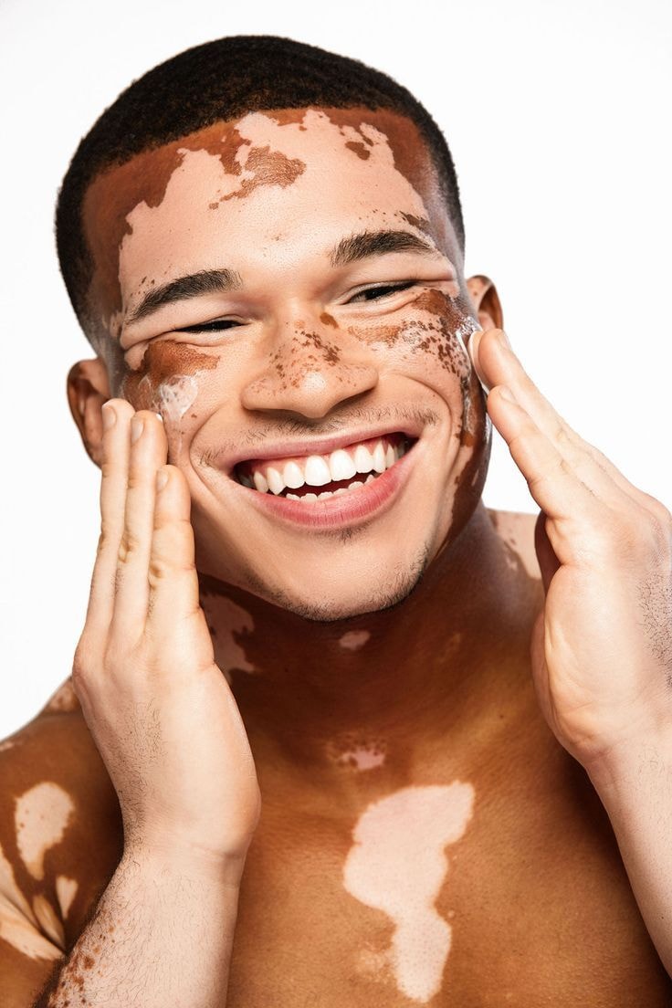 Smiling portrait of the same creator